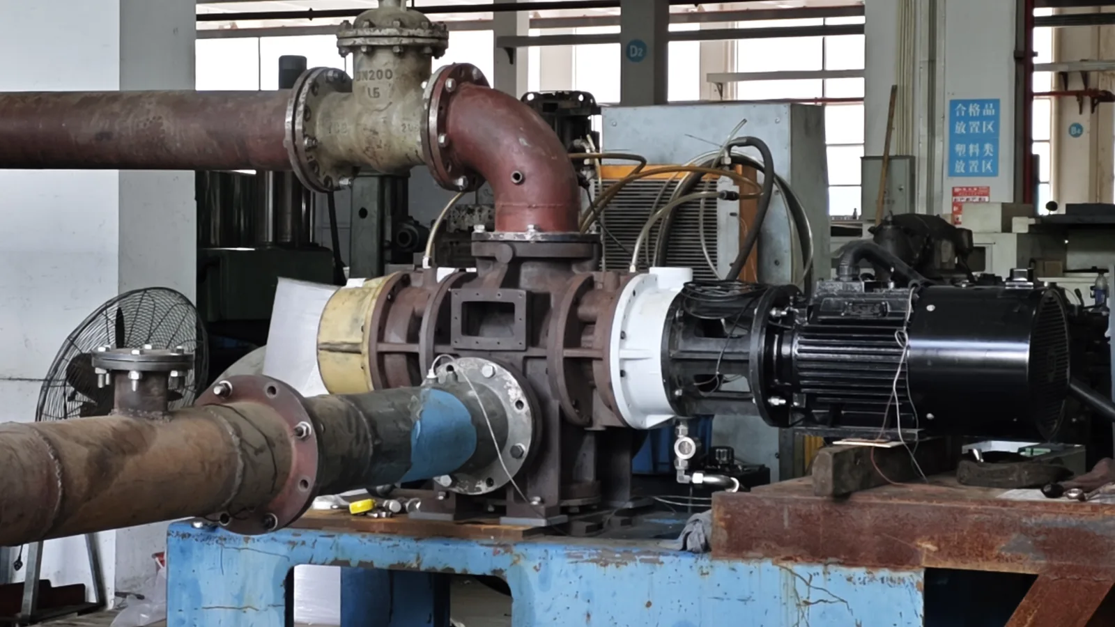 SC TF140 dry screw vacuum pump connected to process piping during a test setup; shown as a system-configuration reference, not proof of a specific process result