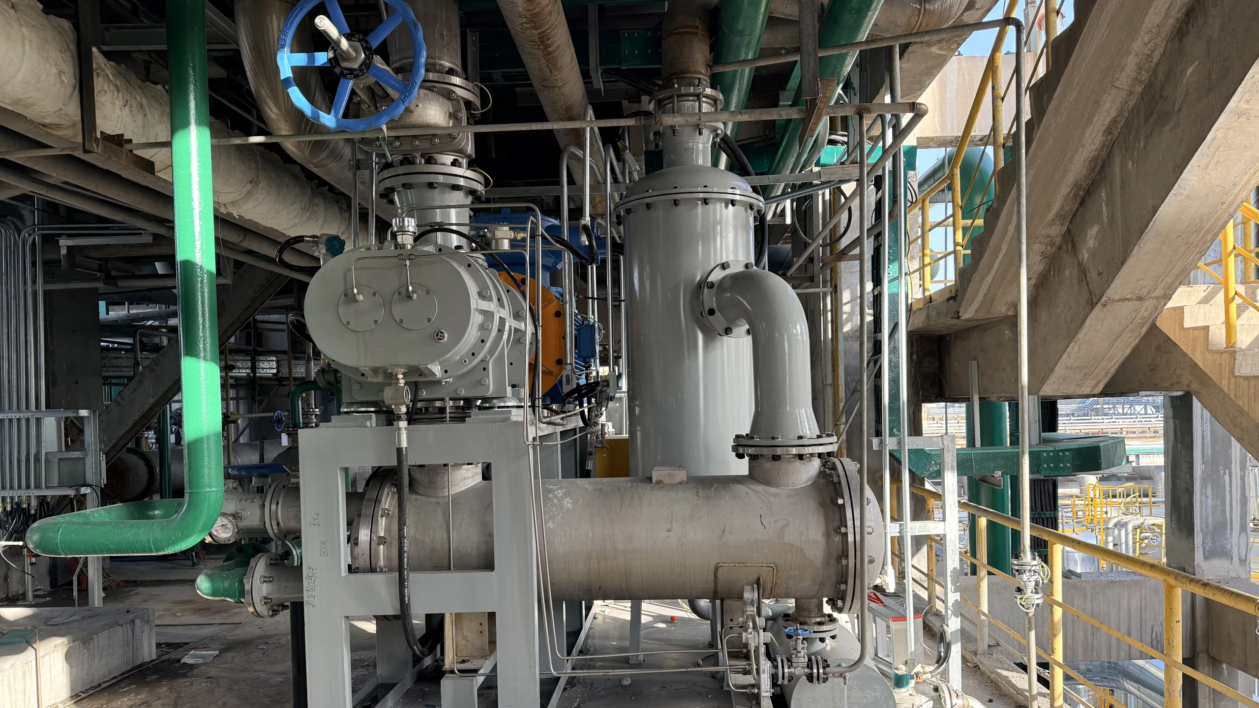 Industrial screw vacuum package with connected process piping, shown only as general dry screw interface-review context; it does not show a shared-header replacement configuration or a performance comparison.